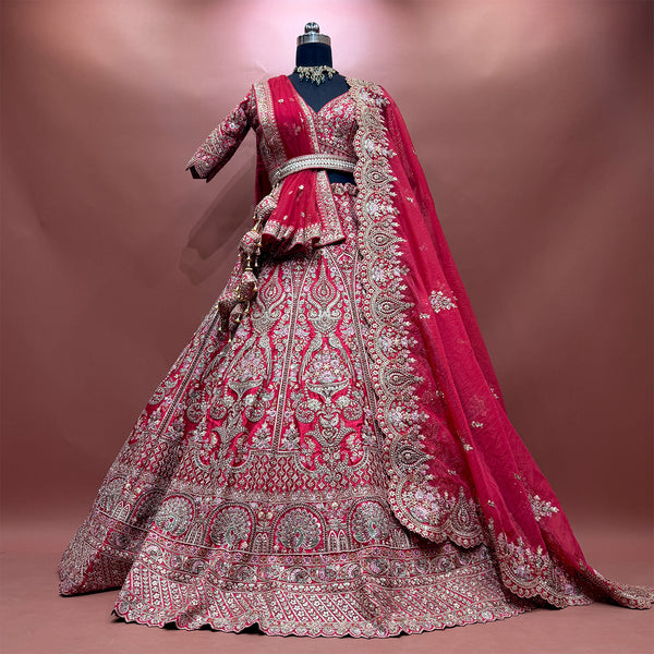 Pink embroidered bridal lehenga on mannequin with flared skirt and draped dupatta