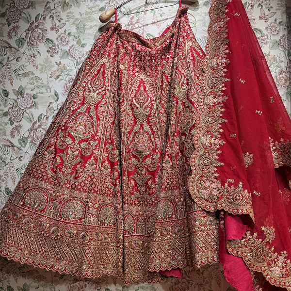 Red lehenga skirt with intricate zari embroidery and stones, plus embellished dupatta edge
