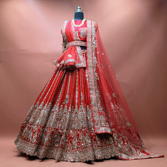 Red raw silk bridal lehenga set with blouse and two net dupattas on mannequin