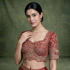 Red embroidered blouse with square neckline and pearl necklace detail, close-up