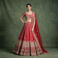 Red bridal lehenga with embroidered blouse and sheer dupatta, full-length view