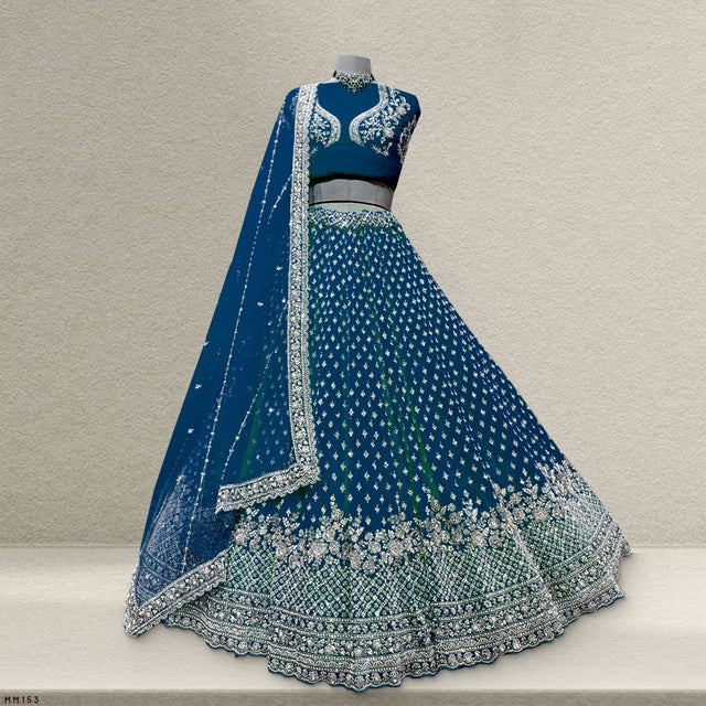 Blue lehenga on mannequin with silver border, full skirt and draped matching dupatta