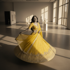 Yellow embellished georgette lehenga with wide flared skirt and flowing dupatta
