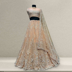 Peach sequin lehenga set with embroidered cropped blouse, tiered skirt, and veil dupatta