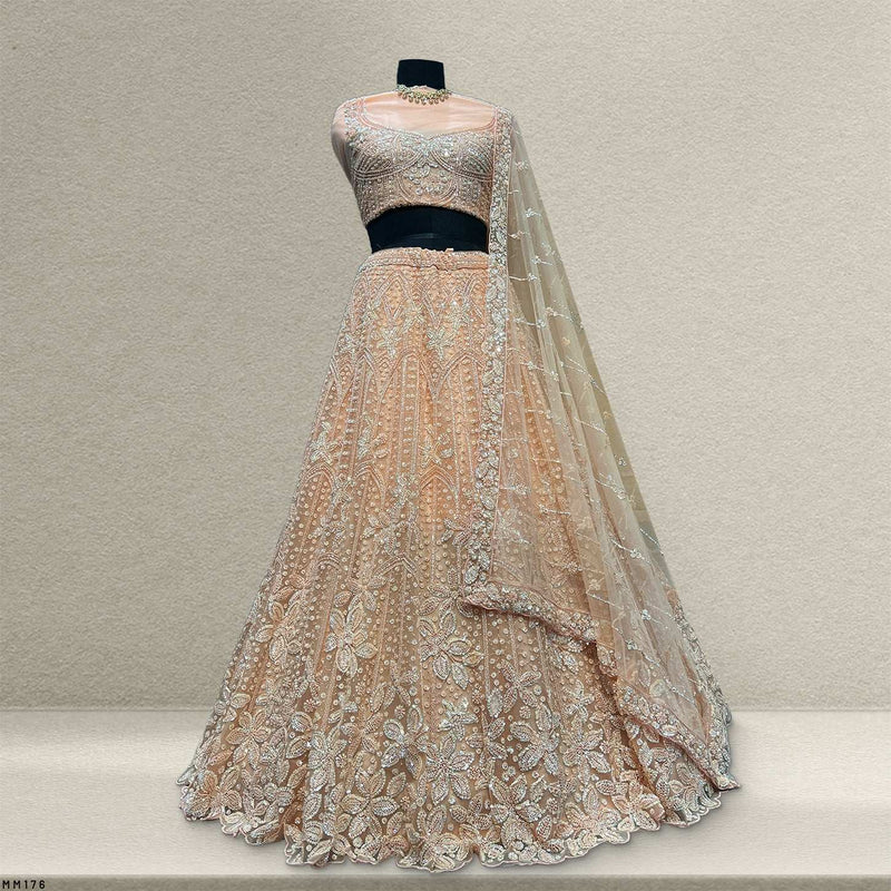 Peach sequin lehenga set with embroidered cropped blouse, tiered skirt, and veil dupatta