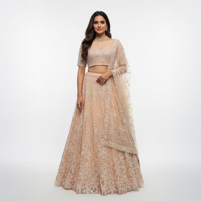 Pastel peach beaded lehenga with cropped blouse and draped net dupatta