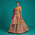 Multicolor Banarasi lehenga with orange-gold blouse and heavy embellished border