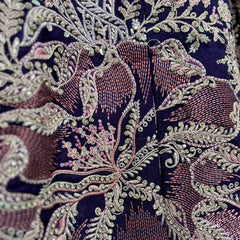 Close-up of dark purple lehenga embroidery with silver sequins and pink accents