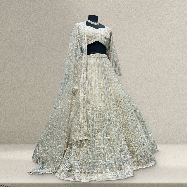 Off-white embellished lehenga with matching blouse and sheer lace dupatta