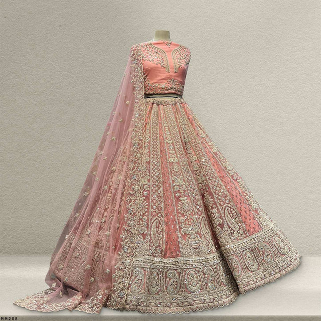 Dusty pink lehenga skirt with ornate border, sheer dupatta, and embroidered bodice