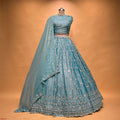 Blue lehenga set with bead-and-pearl embroidery, full skirt, and matching dupatta