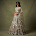 Embroidered sage green lehenga with pearl-like floral motifs and matching sheer dupatta