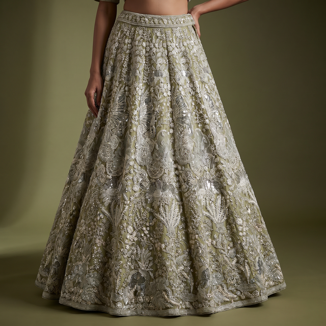Embroidered sage green lehenga skirt with rich floral motifs and shimmering embellishment