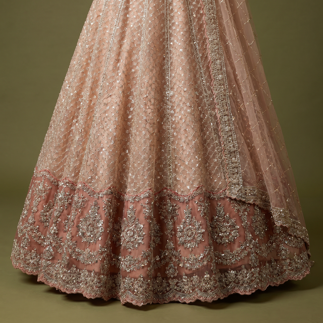 Peach lehenga skirt with dense sequins and ornate cutdana floral border at hem