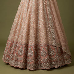 Peach embellished lehenga skirt with pearl-like pattern and ornate border