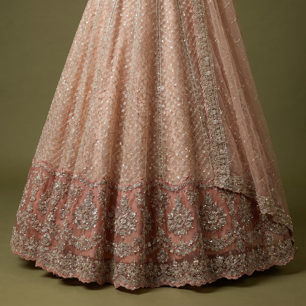 Peach embellished lehenga skirt with pearl-like pattern and ornate border
