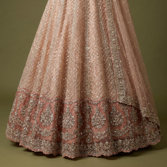 Peach embellished lehenga skirt with pearl-like pattern and ornate border