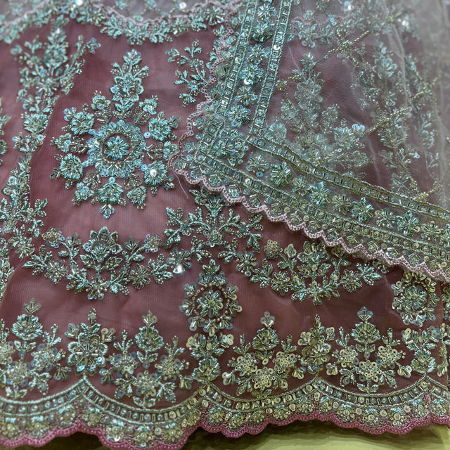 Peach lehenga skirt with turquoise-gold cutdana embroidery and sequined motif border