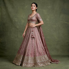 Mauve designer lehenga with embroidered blouse and full flared skirt, gold border