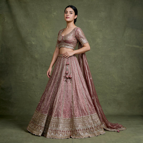 Mauve designer lehenga with embroidered blouse and full flared skirt, gold border