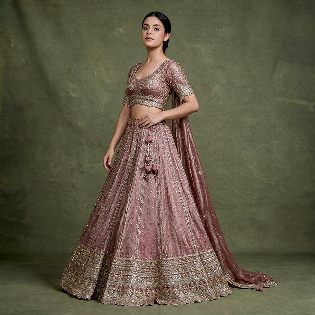 Mauve designer lehenga with embroidered blouse and full flared skirt, gold border