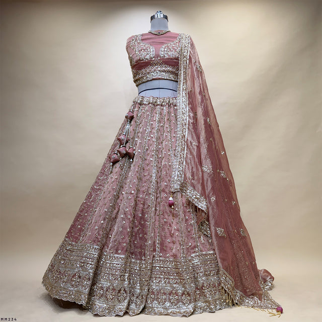 Mauve lehenga set with embellished bodice, flared skirt, and draped sheer veil