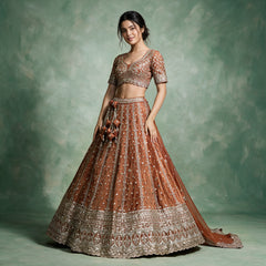 Rich orange designer lehenga with short-sleeve embellished blouse, flared skirt