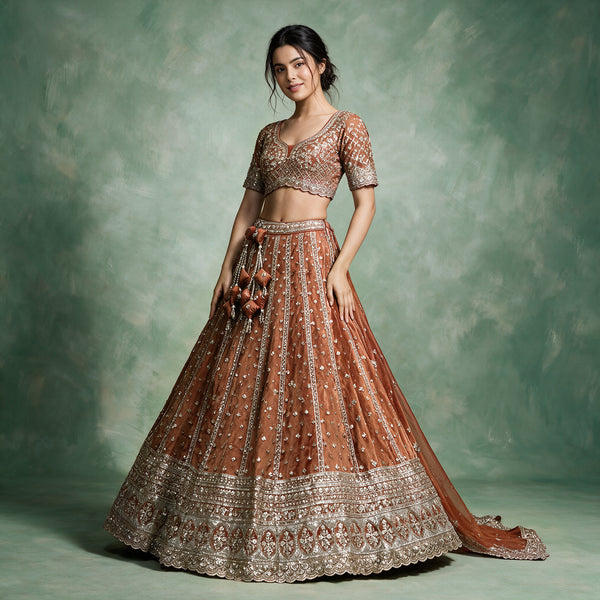 Rich orange designer lehenga with short-sleeve embellished blouse, flared skirt