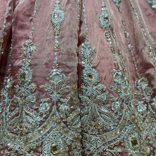 Close-up of lehenga fabric with teal, gold and crystal bead embroidery