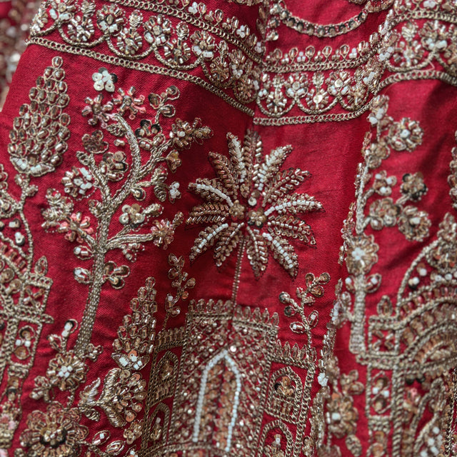 Red lehenga bodice with dense jeweled mirror-work and floral embroidery