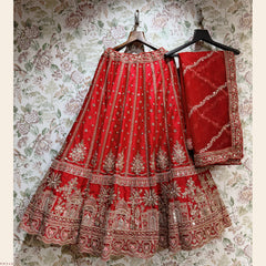 Red bridal lehenga and matching dupatta set with gold embroidery, on hangers