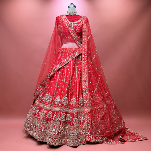 Red bridal lehenga with ornate border embroidery and sheer double dupatta