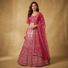 Embroidered pink lehenga with ornate border and sheer magenta dupatta