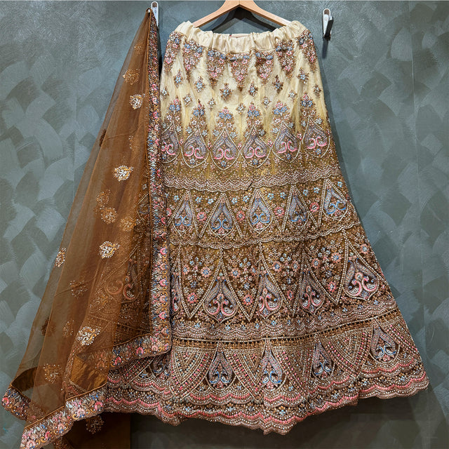 Embroidered tiered lehenga skirt with matching sheer dupatta on hanger