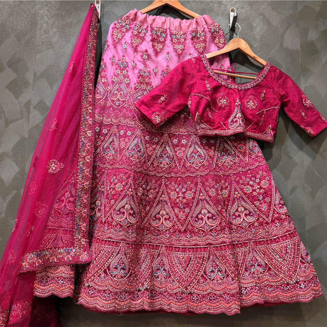 Pink and magenta embroidered lehenga set with net dupatta on hangers