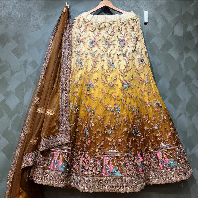 Embroidered lehenga skirt with floral motifs and gold net dupatta with ornate border