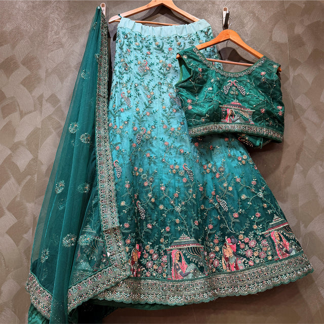 Teal and green embroidered lehenga skirt with matching blouse, plus net dupatta