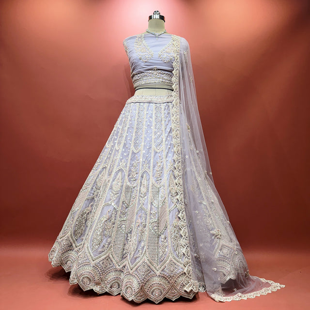Lavender lehenga dress with circular motif hem, fitted waist, and draped net dupatta