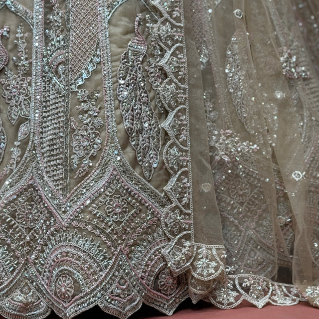 Close-up of ivory net lehenga embroidery with cutdana, dori lines, and peacock motifs