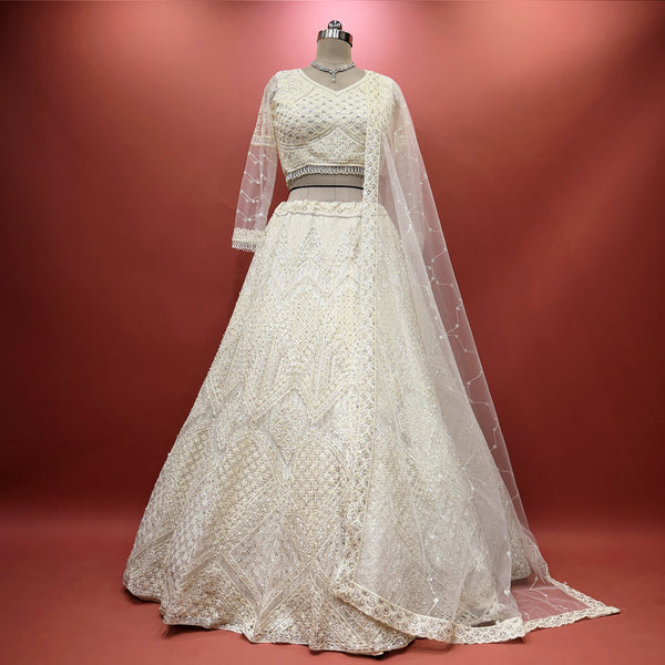 Off-white embellished lehenga with net dupatta and matching belt, full flare skirt