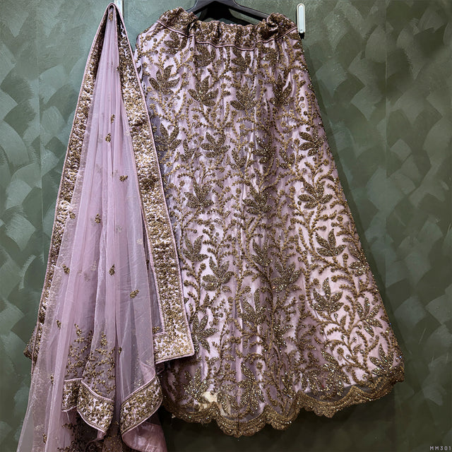 Embroidered purple lehenga with gold floral motifs and matching sheer dupatta