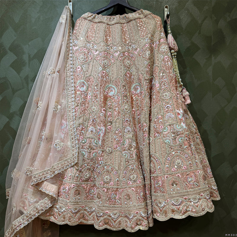 Peach embellished lehenga with matching blouse and sheer embroidered dupatta