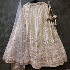 Ivory raw silk bridal lehenga skirt with embroidered hem and sheer dupatta