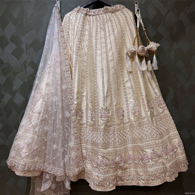 Ivory bridal lehenga back with embroidered yoke, gathered skirt pleats, and sheer dupatta