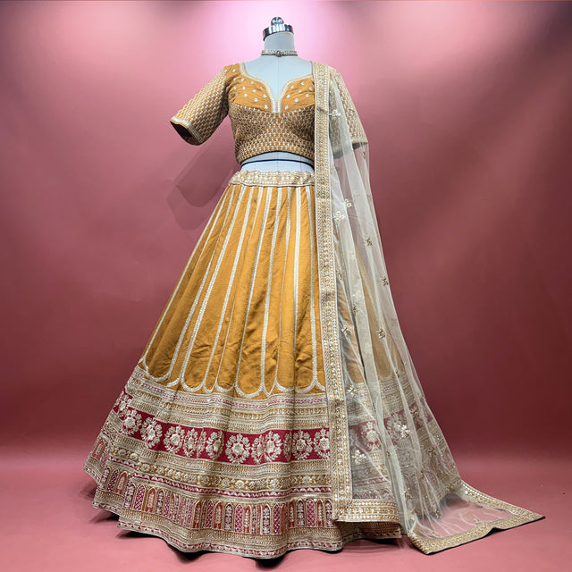 Champagne gold embroidered lehenga with ornate border and sheer dupatta