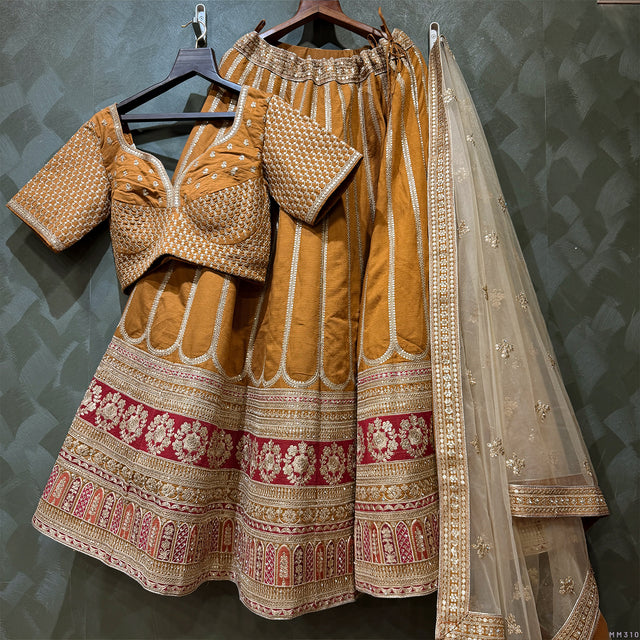 Gold embroidered lehenga set with matching blouse pieces and sheer dupatta