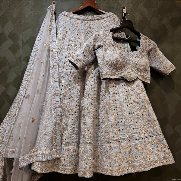 Sky blue lehenga and blouse set with intricate silver mirrorwork, sheer net dupatta