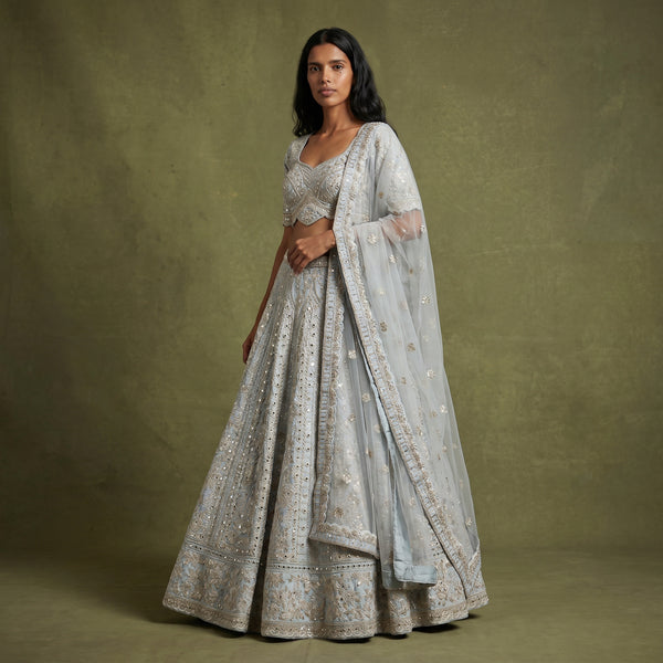 Sky blue lehenga with gold mirrorwork detailing and sheer dupatta, flared skirt