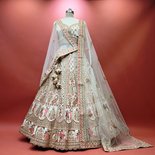 Ivory bridal lehenga with multicolored embroidered panel and sheer dupatta