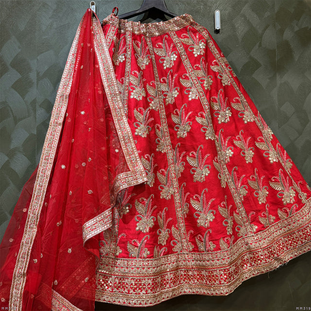 Red bridal lehenga with gold embroidered motifs, wide border trim and dupatta